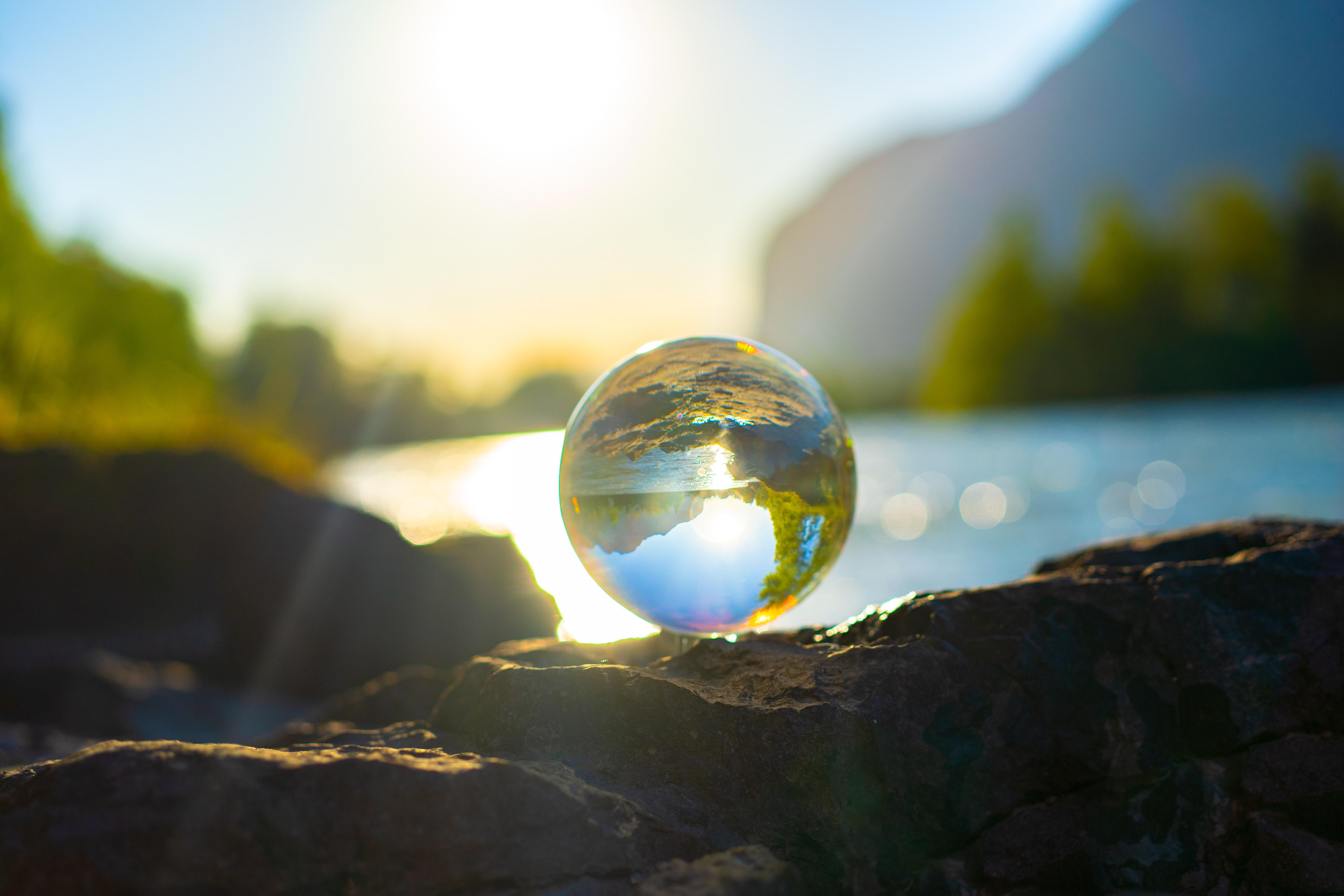 A clear glass ball reflecting the landscape.