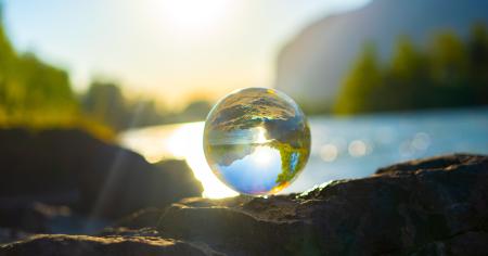 A clear glass ball reflecting the landscape.